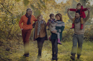 Happy multi-generation family spending an autumn day in the park