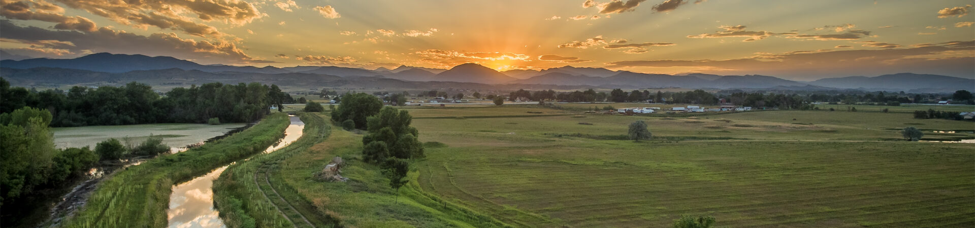 Sunset Over Rocky Mountains And Foothills With An Irrigation Ditch