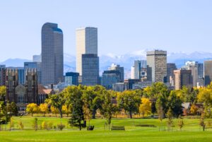 Image of downtown Denver skyline and Rocky Mountains in the background.